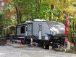 A travel trailer in a gravel site at PROSPECT MOUNTAIN CAMPGROUND - thumbnail