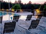 Pool-side lounge chairs at dusk - thumbnail