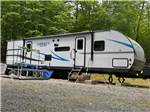 A large RV with picnic table at site - thumbnail