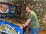 A man playing a pinball game at LONE DUCK CAMPGROUND - thumbnail