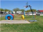 Playground area with basketball court at MIDLAND/ODESSA RV PARK - thumbnail