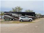 Motorhome in campsite with picnic table at MIDLAND/ODESSA RV PARK - thumbnail