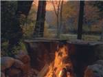 A large fire burning at sunset at NATURES CAMPSITES - thumbnail