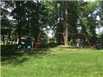 Red swingset in the grass at Cherokee Park Campground - thumbnail