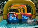 Children playing on a water tube ride - thumbnail