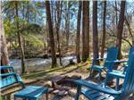 A fire pit and chairs by the river at GREENBRIER CAMPGROUND - thumbnail