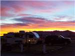 RVs parked in sites at sunset at VAN HORN RV PARK - thumbnail