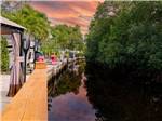 View larger image of RVs parked at pier facing water and trees at NORTHTIDE NAPLES RV RESORT image #1
