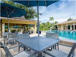 View larger image of Close-up of patio table near pool at NORTHTIDE NAPLES RV RESORT image #11
