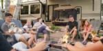A family around a campfire in an RV site - thumbnail