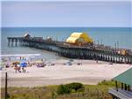 View larger image of The people on the beach and pier at APACHE FAMILY CAMPGROUND  PIER image #2