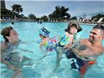 A family playing in the pool at APACHE FAMILY CAMPGROUND & PIER - thumbnail