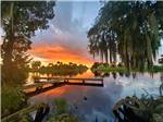 View larger image of A view of the dock at sunset at ZACHARY TAYLOR RV RESORT image #1