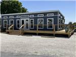 A blue building with a deck at ZACHARY TAYLOR WATERFRONT RV RESORT - thumbnail