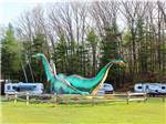 View larger image of Trailers camping next to a large dinosaur statues at ALPINE LAKE RV RESORT image #5