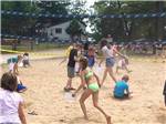Kids and adults in sand volleyball court at BUFFALO LAKE CAMPING RESORT - thumbnail