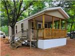 A small cabin with a porch - thumbnail