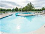 Swimming pool with outdoor seating at PLYMOUTH ROCK CAMPING RESORT - thumbnail