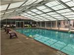 View larger image of Indoor pool with chairs at pool side at MISSION RV PARK image #3