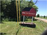 The entrance sign in the shape of a red barn at RED BARN RV PARK - thumbnail