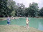 Kids fishing in the pond at The Broken Banjo RV Park - thumbnail