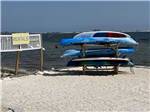 A stack of kayaks on the beach at NAVARRE BEACH CAMPING RESORT - thumbnail