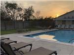 View larger image of The swimming pool area at dusk at COLONIA DEL REY RV PARK image #6