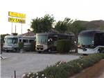 View larger image of Row of big rigs under the park sign at SHADY LANE RV CAMP image #1