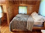 The bed in the cabin rental at MERAMEC CAMPGROUND - thumbnail