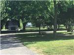 A motorhome parked in a shady site at ENON BEACH CAMPGROUND - thumbnail