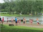 Kids playing egg toss along the shore at ENON BEACH CAMPGROUND - thumbnail