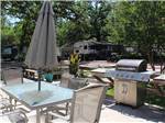 A patio table and barbeque at TAKE-IT-EASY RV RESORT - thumbnail