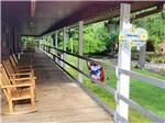 Porch with wooden rocking chairs at Happy Holiday Campground - thumbnail