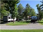 Two trailers parked in gravel sites at GREAT CANADIAN RESORTS & CAMPGROUNDS - thumbnail