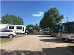 Gravel road lined with big rigs in sites at AB CAMPING RV PARK - thumbnail