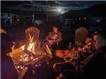 Four guys sitting around a fire at ASPEN RIDGE RV PARK - thumbnail