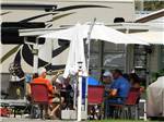 View larger image of A group of people sitting around an RV at RICE CREEK RV RESORT image #7