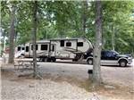 A fifth wheel trailer in a gravel RV site at SALEM FARMS CAMPGROUND - thumbnail