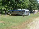 An Airstream in a grassy RV site at SALEM FARMS CAMPGROUND - thumbnail