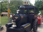 A tractor that looks like a train pulling people at CAMPERS COVE CAMPGROUND - thumbnail