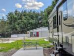 Parked RV and picnic bench at HAPPY TRAVELER RV RESORT - thumbnail