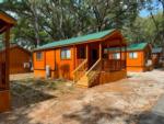 A row of the rental cabins at HAPPY TRAVELER RV RESORT - thumbnail