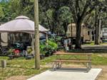 Gazebo, picnic bench and RVs at HAPPY TRAVELER RV RESORT - thumbnail