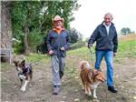 View larger image of Two guys walking dogs at FLYING FLAGS RV RESORT  CAMPGROUND image #6