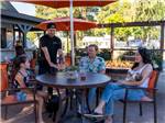 A family sitting at a table at FLYING FLAGS RV RESORT & CAMPGROUND - thumbnail