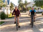 View larger image of A couple riding bikes at FLYING FLAGS RV RESORT  CAMPGROUND image #11