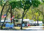 View larger image of The entrance sign with flags at SOUTHERN AIRE RV RESORT image #3