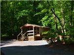 View larger image of A wooden cabin with a deck at PINCH POND FAMILY CAMPGROUND image #11