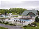 Rectangular pool surrounded by white picket fence at COUNTRY ACRES CAMPGROUND - thumbnail