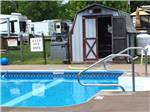 View larger image of View of pool with campers in background at CHERRY GROVE CAMPGROUND image #3